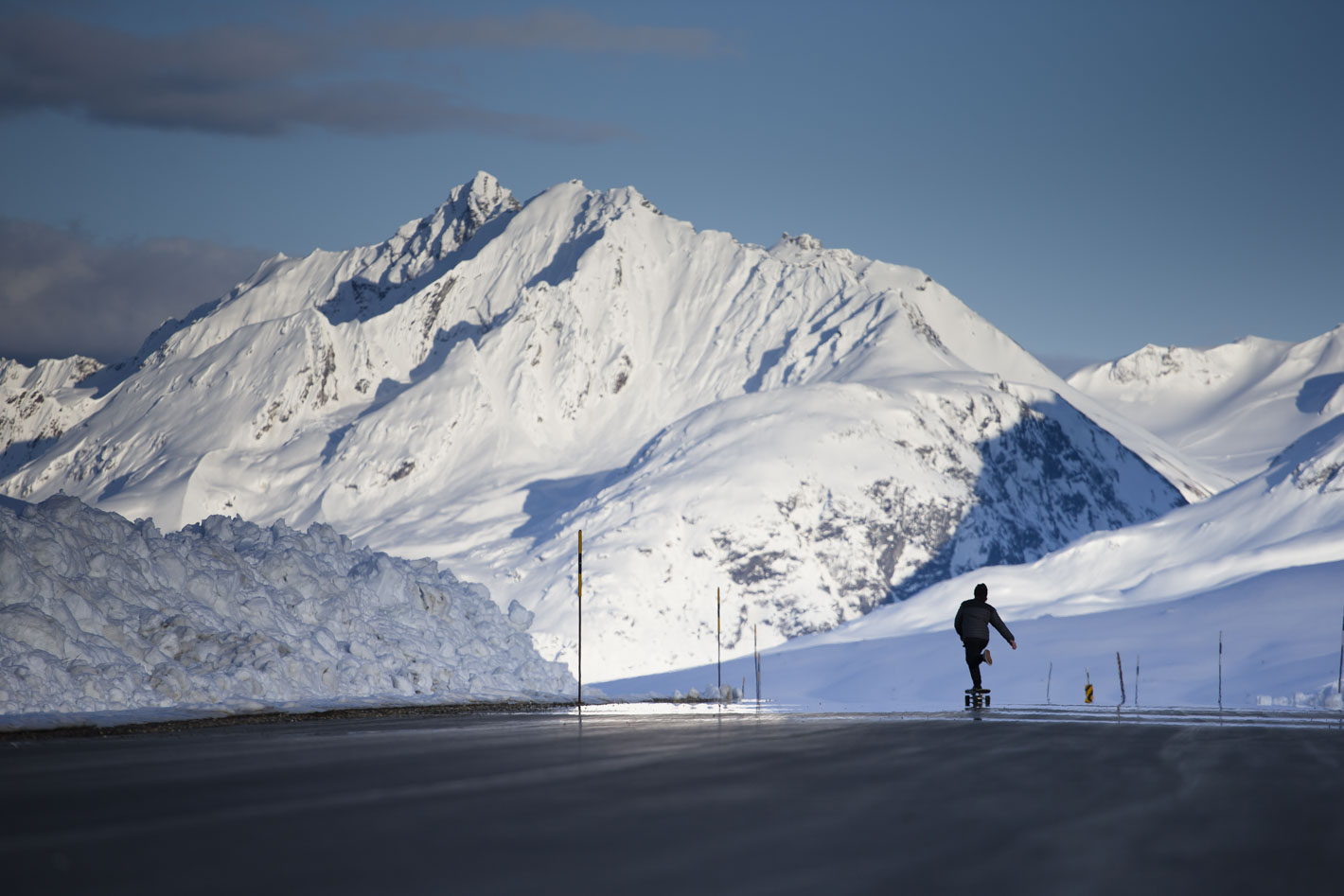 Mike Henitiuk skateboards down a mountain highway. Photo Mason Mashon