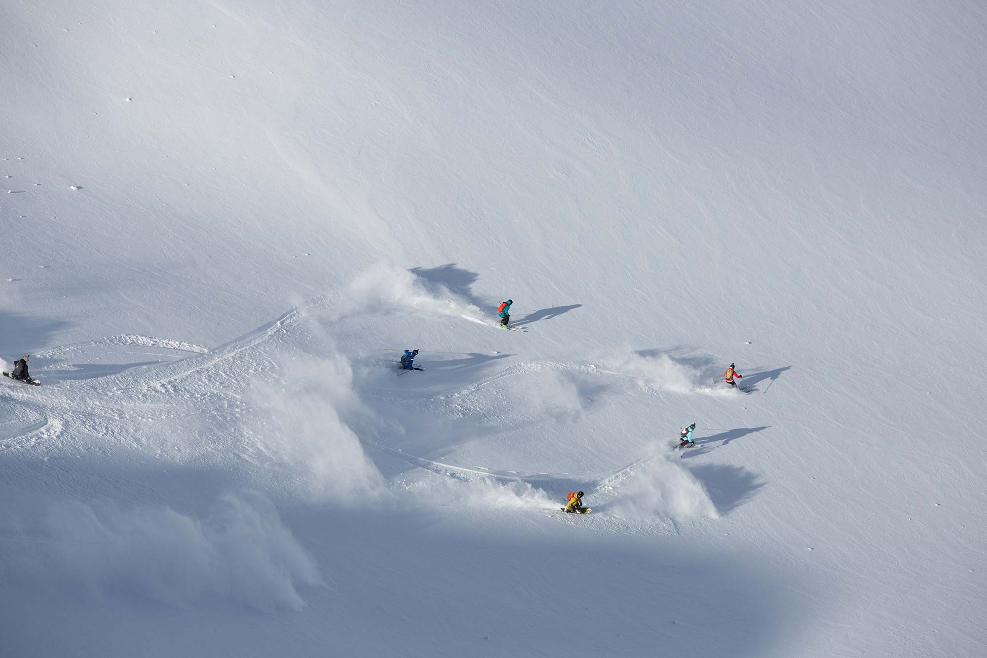 Group skiing and snowboarding during the filming of Shades of Winter COUPLES.