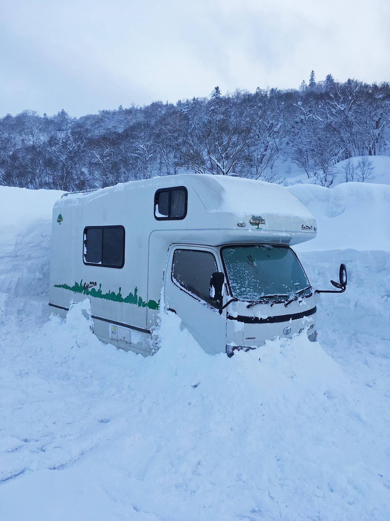 A camper van snowed in in Kiroro, Japan during a ski trip.