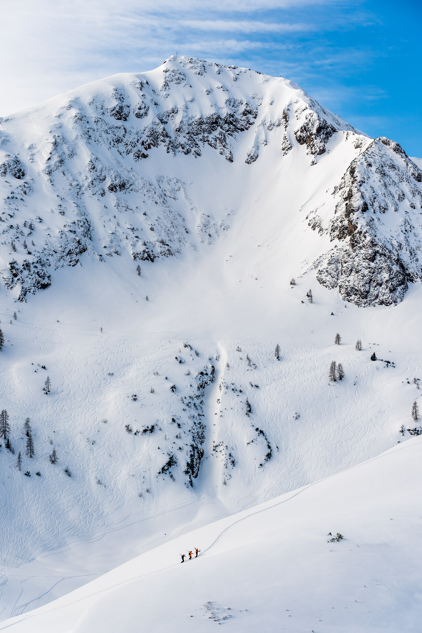Paul Klein, Christian Stadler and Nikki Sagmeister hike beheath the Wildseeloder in Fieberbrunn, Austria.